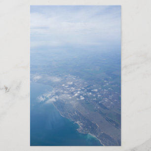 View on the seacoast through the airplane window flyer