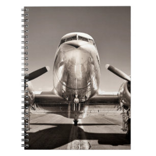 vintage airplane on a runway notebook