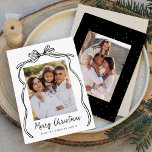 Vintage Black Bow Merry Christmas 2 Photo Holiday Card<br><div class="desc">Celebrate the holiday season with this charming Christmas card featuring your family's photo framed by a festive black bow and ribbon on a crisp white background. "Merry Christmas" is elegantly written in a charming black handwritten script, with space to personalize your family name below. The back of the card showcases...</div>