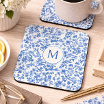 Vintage Blue Chinoiserie Monogram  Coaster<br><div class="desc">This coaster features an elegant, timeless floral design rendered in rich shades of blue against a soft, light background. Delicate botanical elements—blossoms, leaves, and winding stems—flow organically across the surface, creating a balanced composition. The artwork has a hand-illustrated, slightly textured look reminiscent of vintage toile or traditional botanical prints. Varying...</div>