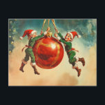 Vintage Christmas Elves With a Huge Ornament Postcard<br><div class="desc">This image is a vibrant, nostalgic illustration featuring two cheerful Christmas elves actively hanging a gigantic, glossy red ornament. Both elves wear matching green outfits trimmed with white fur and red, pointed hats. They are holding onto the golden ribbons attached to the ornament, appearing to be suspended in mid-air with...</div>