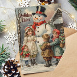 Vintage Christmas Snowman with Children in Snow Holiday Card<br><div class="desc">Celebrate the magic of Christmas with this delightful vintage card featuring a classic snowman surrounded by joyful children. Perfect for sending warm holiday wishes to family and friends!</div>