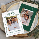 Vintage Green Bow Merry Christmas 2 Photo Holiday Card<br><div class="desc">Celebrate the holiday season with this charming Christmas card featuring your family's photo framed by a festive green bow and ribbon on a crisp white background. "Merry Christmas" is elegantly written in a charming green handwritten script, with space to personalize your family name below. The back of the card showcases...</div>