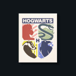 Vintage HOGWARTS™ Stamped Crest Canvas Print<br><div class="desc">Show your house pride in bold, vintage-inspired style with this striking Hogwarts™ crest design. Featuring graphic silhouettes representing the four iconic houses — Gryffindor™, Slytherin™, Hufflepuff™, and Ravenclaw™ — this artwork blends classic symbolism with a modern, retro aesthetic. Each house emblem is set within a clean, color-blocked shield, creating a...</div>