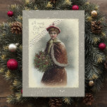 Vintage Lady in Snow with Christmas Greeting Holiday Card<br><div class="desc">Lovely Victorian lady dressed for winter in red cape holding a bouquet of holly in snow with Christmas greeting.</div>