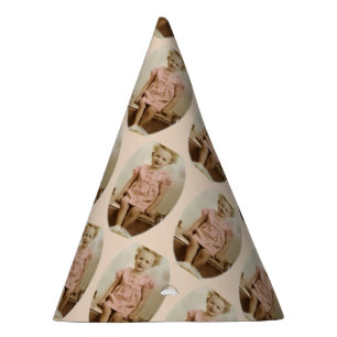 Vintage little blonde girl in pink dress party hat