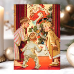 Vintage Mommy Kissing Santa Claus Christmas Holiday Card<br><div class="desc">Capture the nostalgia and charm of Christmas with this delightful vintage holiday card featuring a classic scene of children catching Mommy kissing Santa Claus by the Christmas tree. The beautifully illustrated design brings warmth and humor to your holiday greetings, perfect for sharing with friends and family. This card evokes the...</div>