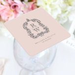 Vintage Monogram Crest Names Blush Pink Wedding Square Paper Coaster<br><div class="desc">This elegant design features an ornate,  regency vintage-inspired crest of acanthus leaves framing two monogram initials in open serif font,  stacked vertically and separated by a thin horizontal line. Add the couple's names and wedding date below. The design and text are in charcoal grey on a blush pink background.</div>