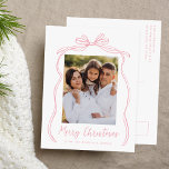 Vintage Pink Bow Merry Christmas Photo Holiday Postcard<br><div class="desc">Celebrate the holiday season with this charming Christmas postcard featuring your family's photo framed by a festive pink bow and ribbon on a crisp white background. "Merry Christmas" is elegantly written in a charming pink handwritten script, with space to personalize your family name below. The back of the postcard displays...</div>