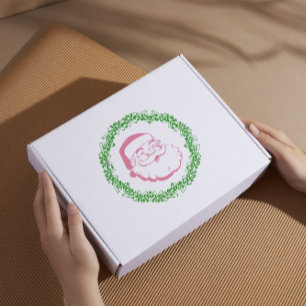 Vintage pink santa frame by a green wreath xmas