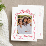 Vintage Red Bow Merry Christmas Photo Holiday Postcard<br><div class="desc">Celebrate the holiday season with this charming Christmas postcard featuring your family's photo framed by a festive red bow and ribbon on a crisp white background. "Merry Christmas" is elegantly written in a charming red handwritten script, with space to personalize your family name below. The back of the postcard displays...</div>