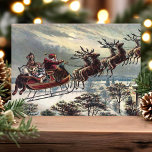 Vintage Retro Santa Claus Reindeer Sleigh Holiday Card<br><div class="desc">Vintage Retro Santa Claus Reindeer Sleigh Holiday Card. This design features Santa Claus guiding his reindeer sleigh through the night sky. What a beautiful retro holiday scene. Personalize this custom design with your own inside greeting.</div>