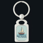 Vintage Sailboat Nautical Inspirational Quote Keychain<br><div class="desc">Set sail toward your dreams with this beautifully illustrated vintage sailboat design, featuring warm wooden tones, billowing cream sails, and gentle ocean waves. The hand-drawn style gives this piece a timeless, maritime charm, perfect for lovers of adventure and the open sea. Below the boat, the phrase “Sail Towards Your Dreams”...</div>