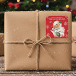 Vintage Santa With Snowflakes Custom Christmas Square Sticker<br><div class="desc">These fun stickers features a mid-century Santa Claus checking over his list with a Merry twinkle in his eye.  A Christmas red back ground with snowflakes showcase the words "a little something from" and then add your family last name or your first name(s).</div>