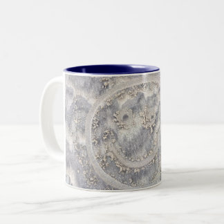 visage dans la plage de sable dessinant la tasse