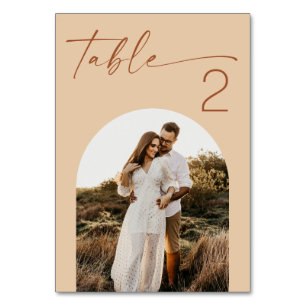 Warm Peach Sand Wedding   Modern Script Arch Photo Table Number