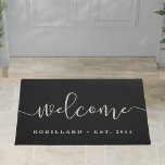 Warm Welcome | Modern Calligraphy Personalized Doormat<br><div class="desc">A great gift for newlyweds or new homeowners,  our personalized welcome doormat in chic and durable black features "welcome" in modern,  elegant handwritten calligraphy script. Personalize with your family name and year established in classic block lettering.</div>