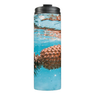 Water droplets on brown plant thermal tumbler
