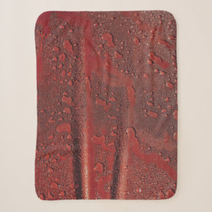 Water drops on red hood sherpa blanket