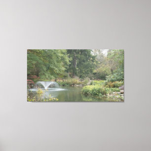 Water fountain in garden pond canvas print