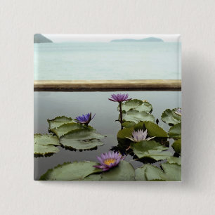 Water lilies in pond by ocean 2 inch square button