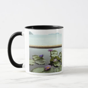 Water lilies in pond by ocean mug