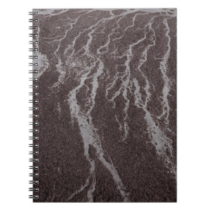 Water on sand on shore notebook