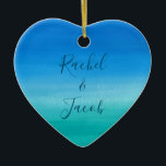 Watercolor Beach Wedding Couple Ceramic Ornament<br><div class="desc">This beachy wedding design features a background of deep blues and greens with space on the front for the couple's names and the wedding date on the back. Click the customize button for more flexibility in modifying the text! Variations of this design as well as coordinating products are available in...</div>