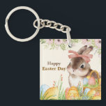 Watercolor Happy Easter Day Floral Bunny with Bow Keychain<br><div class="desc">Celebrate the joy of Easter with this elegant watercolor illustration — a sweet brown-and-white bunny wearing a soft pink bow, nestled among vibrantly painted eggs in a woven basket, all framed by delicate pink peonies, greenery, and wildflowers. The warm, hand-painted aesthetic evokes vintage charm and heartfelt sincerity. Includes the tender...</div>