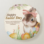Watercolor Happy Easter Day Floral Bunny with Bow Round Pillow<br><div class="desc">Celebrate the joy of Easter with this elegant watercolor illustration — a sweet brown-and-white bunny wearing a soft pink bow, nestled among vibrantly painted eggs in a woven basket, all framed by delicate pink peonies, greenery, and wildflowers. The warm, hand-painted aesthetic evokes vintage charm and heartfelt sincerity. Includes the tender...</div>