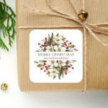 Watercolor Merry Christmas Floral Magnolia Berries Square Sticker<br><div class="desc">This personalized holiday sticker features a watercolor bouquet of white magnolia blossoms,  greenery and red berries. In the middle,  the words "Merry Christmas" appear in olive green serif font on a white background. Personalize the design with your family name below in dark red italics.</div>