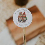 Watercolor Owl Family Personalized Merry Christmas Classic Round Sticker<br><div class="desc">These cute holiday stickers feature a family of three adorable watercolor owls in cozy knitted caps,  scarves and sweaters. The words "Merry Christmas" appear in beige serif font,  with your family's name below.</div>