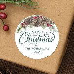 Watercolor Pine Cone Script Merry Christmas Green Classic Round Sticker<br><div class="desc">These personalized Christmas stickers are great for envelope seals on your holiday mail, gifts and favours, and more. They feature elegant script calligraphy, family name and year, and is decorated with watercolor pine cones, greenery sprigs, and burgundy red holly berries. Check out the collection for matching products, or contact me...</div>