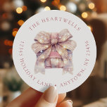 Watercolor Pink Present Christmas Return Address Classic Round Sticker<br><div class="desc">This holiday return address sticker features a watercolor present in shades of pink,  dusty rose and neutral shades topped with a large bow under a light snowfall. Add your family's name around the top edge in dusty rose serif font and your address below.</div>