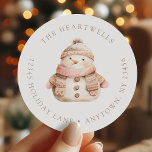 Watercolor Pink Snowman Christmas Return Address Classic Round Sticker<br><div class="desc">This holiday return address sticker features a pink and beige watercolor snowman in a cozy knitted scarf and hat. Add your family's name around the top edge in beige serif font and your address below.</div>