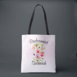 Watercolor Wildflower Bouquet Bridesmaid Wedding Tote Bag<br><div class="desc">This beautiful tote is perfect as a wedding swag bag for thanking your bridesmaids. It features a lovely hand painted bouquet of wildflowers, pansies, or violets on a pale pink watercolor background. The caption across the top reads: Bridesmaid, and there is space for her name below. Perfect for a spring...</div>