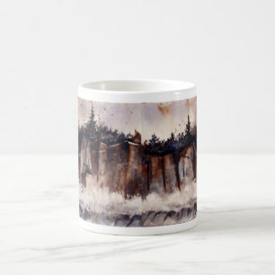 Waves crash against a tall cliff birds soar above coffee mug