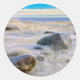 Waves crashing on shoreline rocks classic round sticker