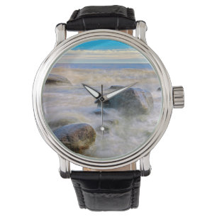 Waves crashing on shoreline rocks watch
