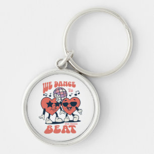 we dance to the same beat keychain