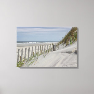 Weathered fence and sand dunes at the beach canvas print