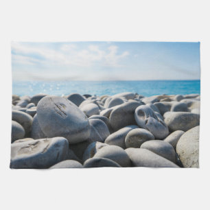 Weathered rock beach with sea and sky kitchen towel