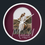 Wedding Arch Photo Burgundy Clock<br><div class="desc">A special keepsake features your wedding photo in an elegant arch design with the text "Married" in chic text along with your names and wedding date on a burgundy background wall clock. Beautiful gift for your family and a fabulous memory to display in your own home. BACKGROUND colour can be...</div>