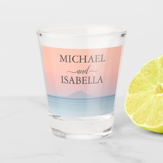Wedding by the sea under peachy sky sunset shot glass (Front)