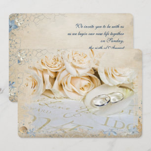 wedding rings on rose petal invitation