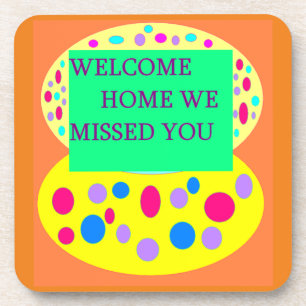 Welcome home message on a coaster orange green