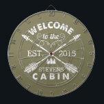 Welcome to the Cabin | Rustic Arrows Personalized Dartboard<br><div class="desc">Spend your leisurely hours playing darts with this fun, unique dartboard. Design features an olive green background with "Welcome to the [Name] Cabin" in rustic block text and two crossed arrows. Customize with your family name and the year established. Makes an awesome housewarming present or gift for your weekend hosts!...</div>