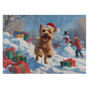 Wheaten Terrier Running in Snow with Christmas Hat Cutting Board