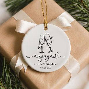 Whimsical Cheers Our First Christmas Engaged Ceramic Ornament