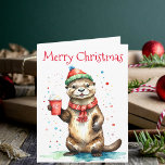 Whimsical Christmas Otter with Festive Hat  Card<br><div class="desc">This delightful Christmas greeting card features an adorable otter standing upright, dressed in a festive red and green striped hat with a fluffy pom-pom and a cozy red scarf with white fringe. The otter holds a red cup adorned with a white snowflake design, filled with a whipped cream-topped beverage. Above...</div>
